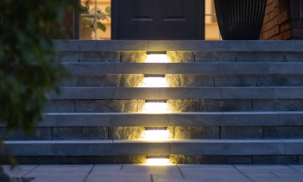 custom retaining wall with glass railings lighting ahs toronto