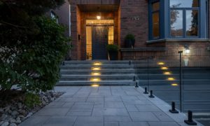 custom retaining wall with railings lighting glass